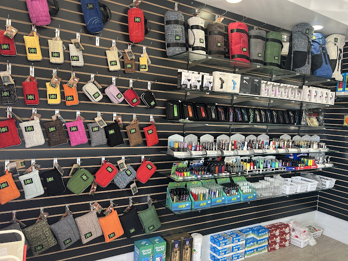 A store display with a variety of handbags hanging on the wall