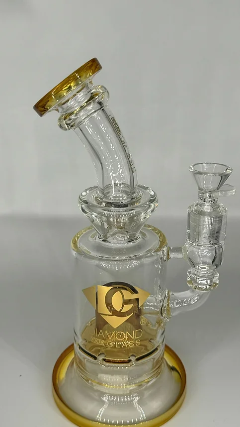 A clear glass pipe with a gold top