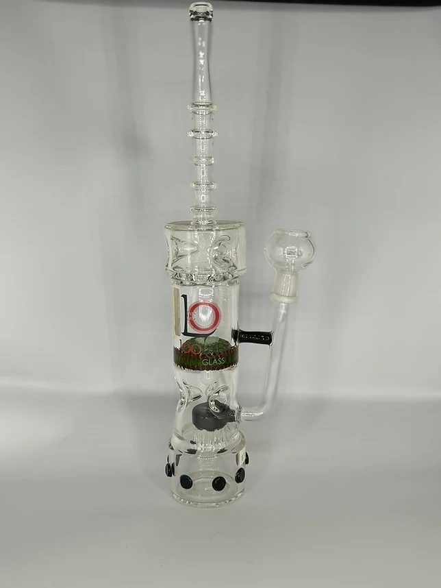 A glass bong with a clock on top of it