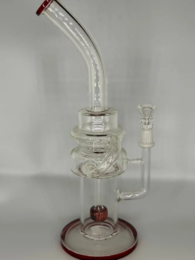 A glass bong with a red base and a red handle